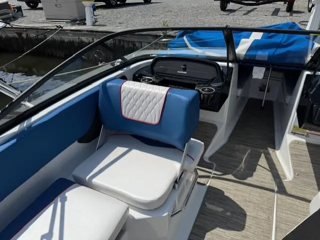 Slide: The Image of 2021 Glastron GX 210 Sport boat interior with blue and white seating and dashboard. - 16