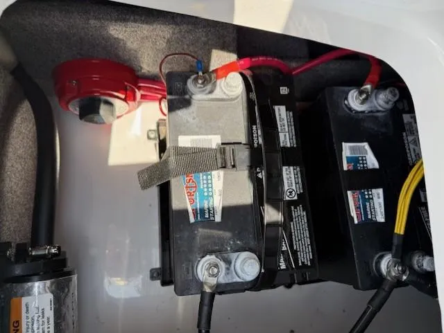 Slide: The Image of Battery compartment of 2021 Glastron GX 210 Sport boat with wiring and connections. - 21