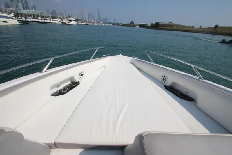 Slide: The Image of 2018 Cobalt A36 boat with spacious deck, cup holders, and scenic waterfront view. - 10
