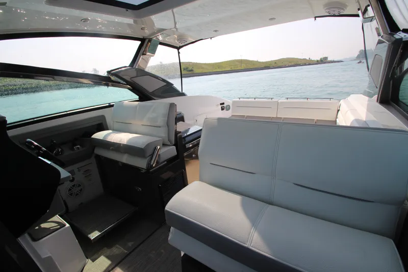 Slide: The Image of Interior of a 2018 Cobalt A36 boat with luxurious seating and scenic water view. - 14