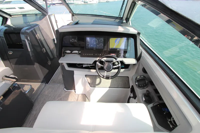 Slide: The Image of Interior cockpit of 2018 Cobalt A36 boat with modern navigation system and steering wheel. - 17