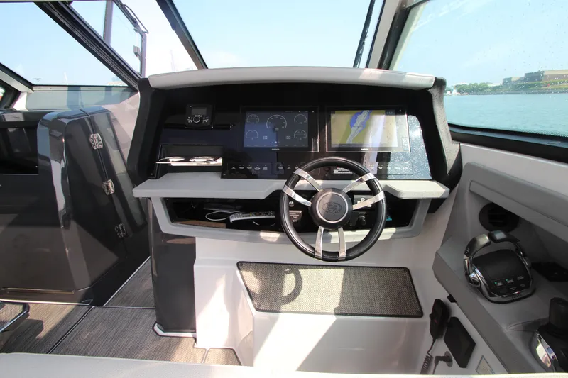 Slide: The Image of Cockpit of 2018 Cobalt A36 boat with modern steering and navigation displays. - 18