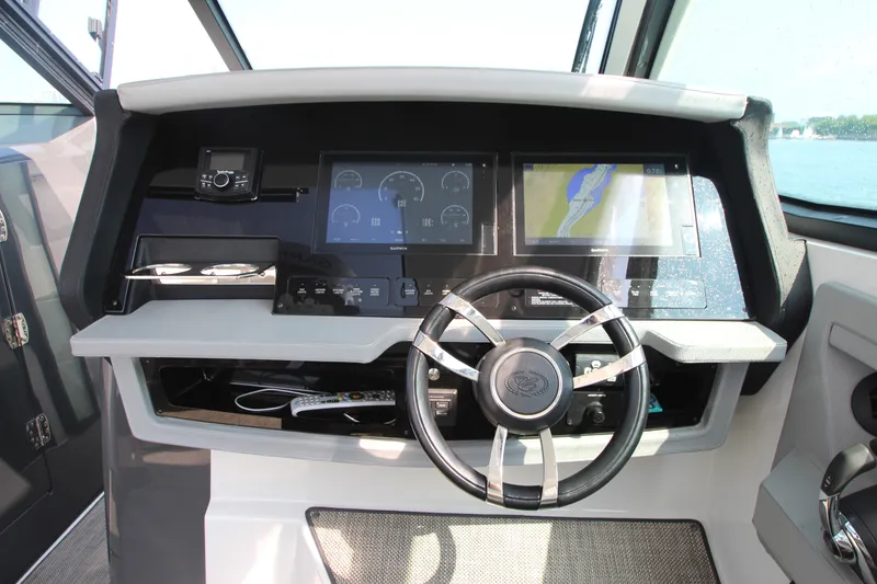 Slide: The Image of Helm of 2018 Cobalt A36 boat with modern navigation displays and steering wheel. - 19