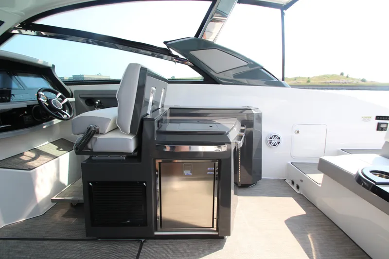 Slide: The Image of Interior of 2018 Cobalt A36 boat with helm, seating, and mini fridge. - 24