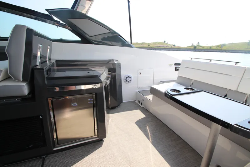 Slide: The Image of 2018 Cobalt A36 boat interior with seating and built-in mini fridge. - 25
