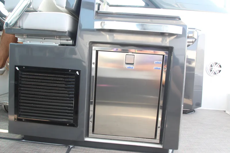 Slide: The Image of 2018 Cobalt A36 boat interior with stainless steel refrigerator and seating. - 26