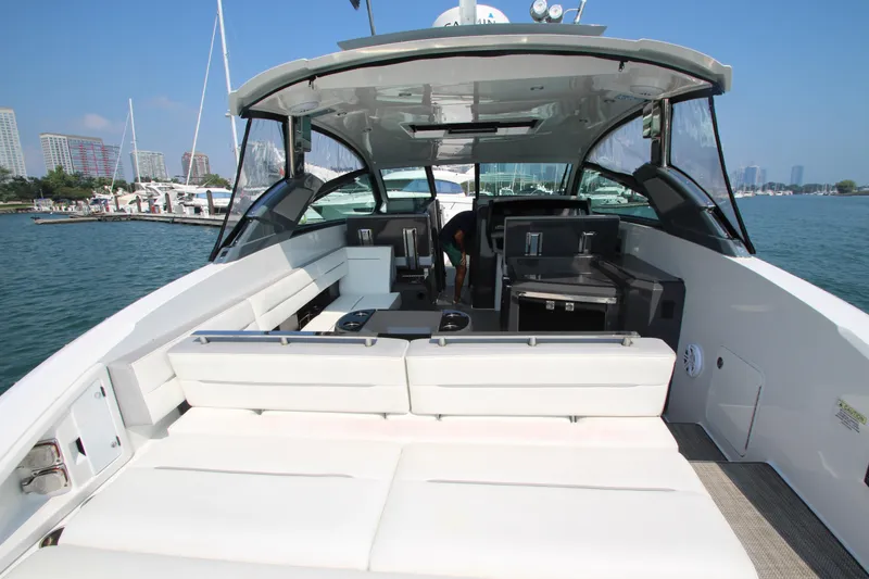 Slide: The Image of 2018 Cobalt A36 yacht interior with white seating, docked in a marina. - 35