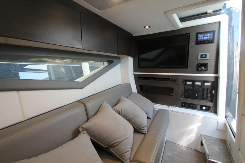 Slide: The Image of Luxurious interior of 2018 Cobalt A36 boat with sofa, TV, and control panel. - 48