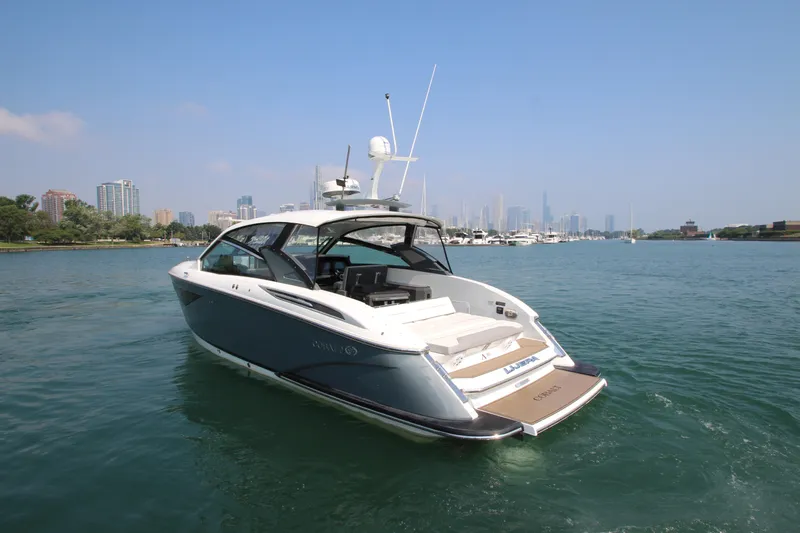 Slide: The Image of 2018 Cobalt A36 boat cruising on a scenic urban waterfront. - 5