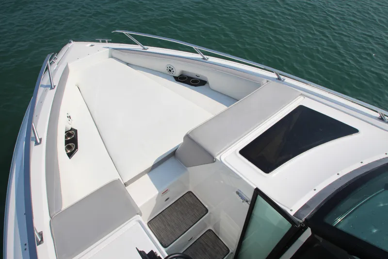 Slide: The Image of 2018 Cobalt A36 boat deck with cushioned seating and railing on calm water. - 6