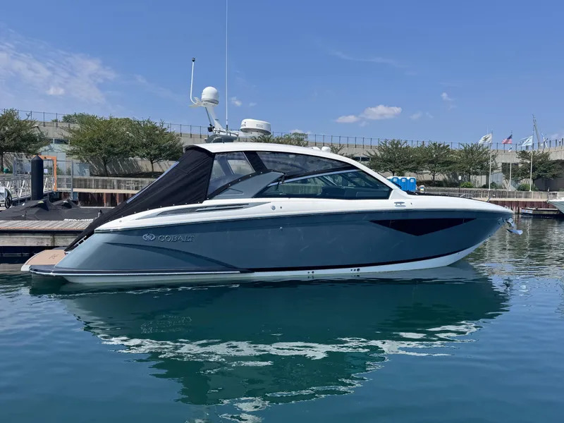 Slide: The Image of 2018 Cobalt A36 boat docked in a marina under a clear blue sky. - 61