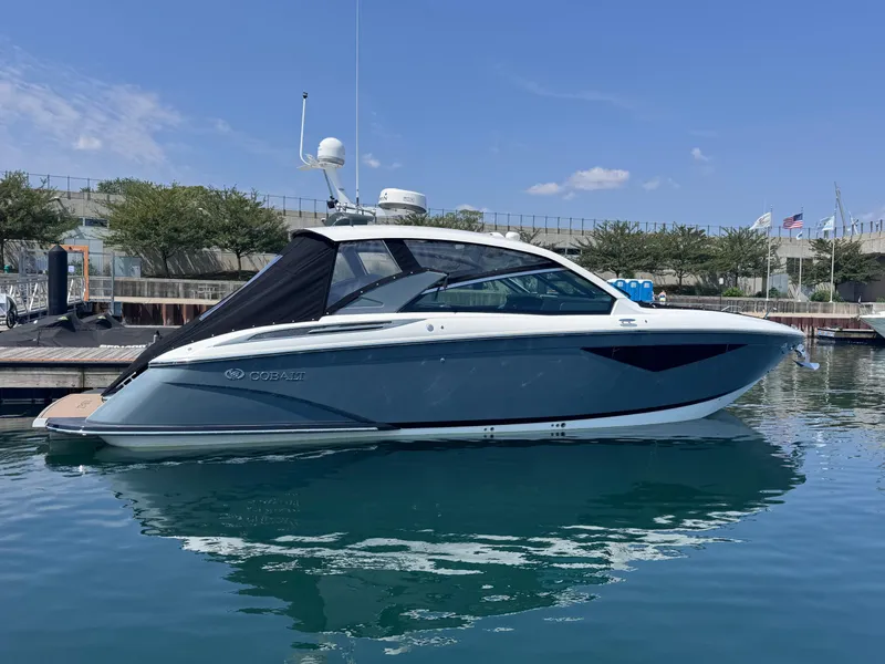 Slide: The Image of 2018 Cobalt A36 boat docked on calm water under clear blue sky. - 62