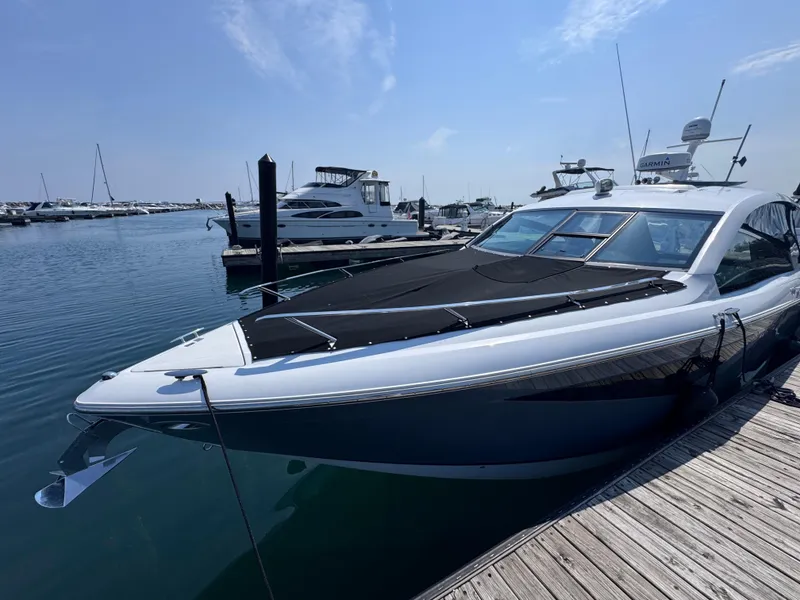 Slide: The Image of 2018 Cobalt A36 yacht docked at marina under clear blue sky. - 65