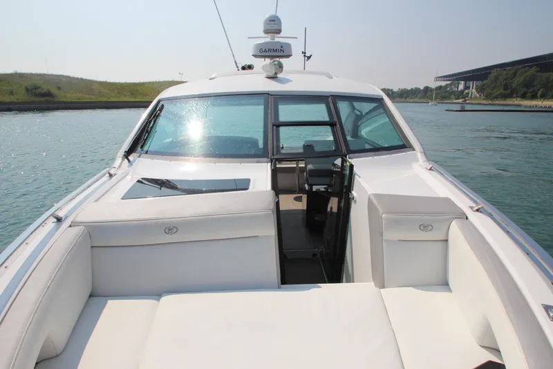 Slide: The Image of 2018 Cobalt A36 boat with white seating, cruising on a sunny day. - 8