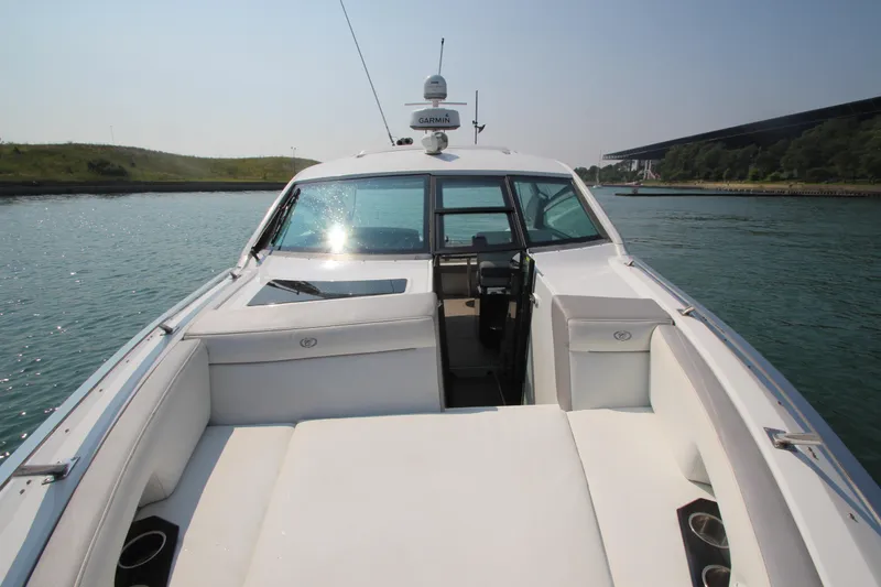 Slide: The Image of 2018 Cobalt A36 boat with white seating, cruising on a sunny day. - 9