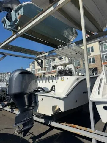 Slide: The Image of 2007 May-Craft 2000 boat on rack, with outboard motor, in marina storage. - 10