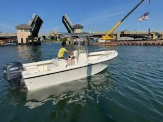 Slide: The Image of 2007 May-Craft 2000 boat on water near drawbridge and crane. - 4
