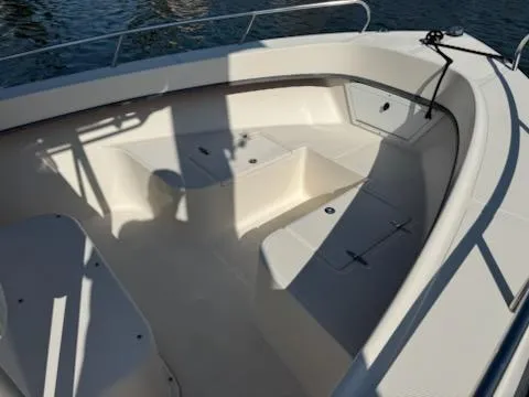 Slide: The Image of 2007 May-Craft 2000 boat interior with seating and storage, docked on water. - 9