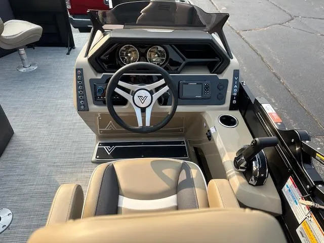 Slide: The Image of Steering console of 2025 Viaggio Lago X-F boat with modern controls and beige seating. - 13
