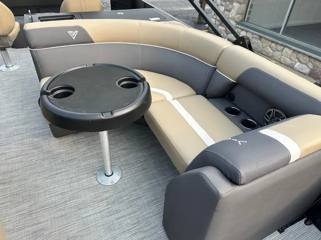 Slide: The Image of Luxurious seating area on 2025 Viaggio Lago X-F boat with round table and cup holders. - 24