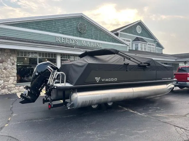 Slide: The Image of 2025 Viaggio Lago X-F pontoon boat parked at Reed's Marine dealership. - 27