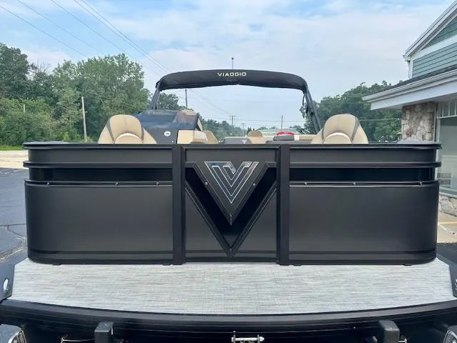 Slide: The Image of 2025 Viaggio Lago X-F pontoon boat with sleek black design and beige seating. - 3