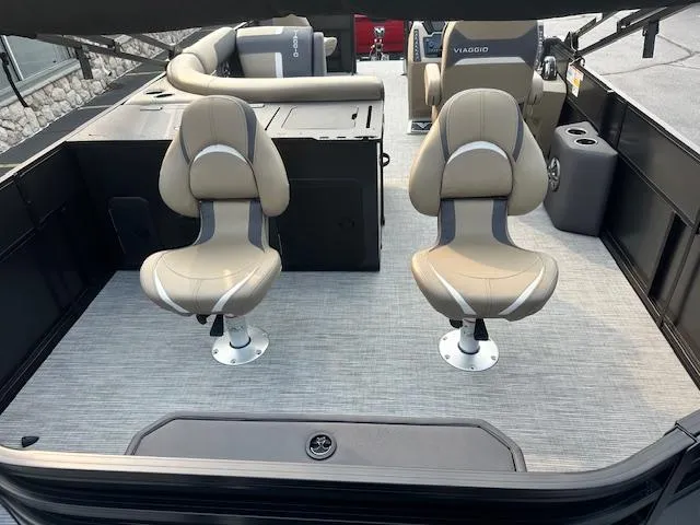 Slide: The Image of 2025 Viaggio Lago X-F boat interior with two beige swivel seats on a gray deck. - 5