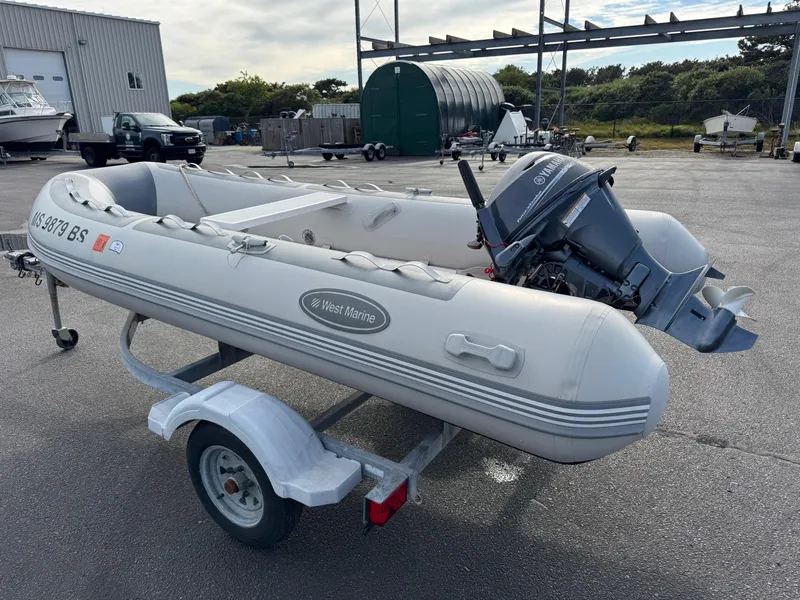 Slide: The Image of 2022 West Marine RIB-350 inflatable boat on trailer with outboard motor. - 2