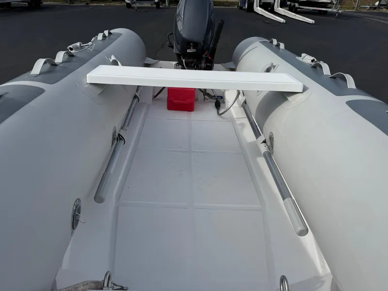 Slide: The Image of 2022 West Marine RIB-350 inflatable boat interior with motor and seating. - 6