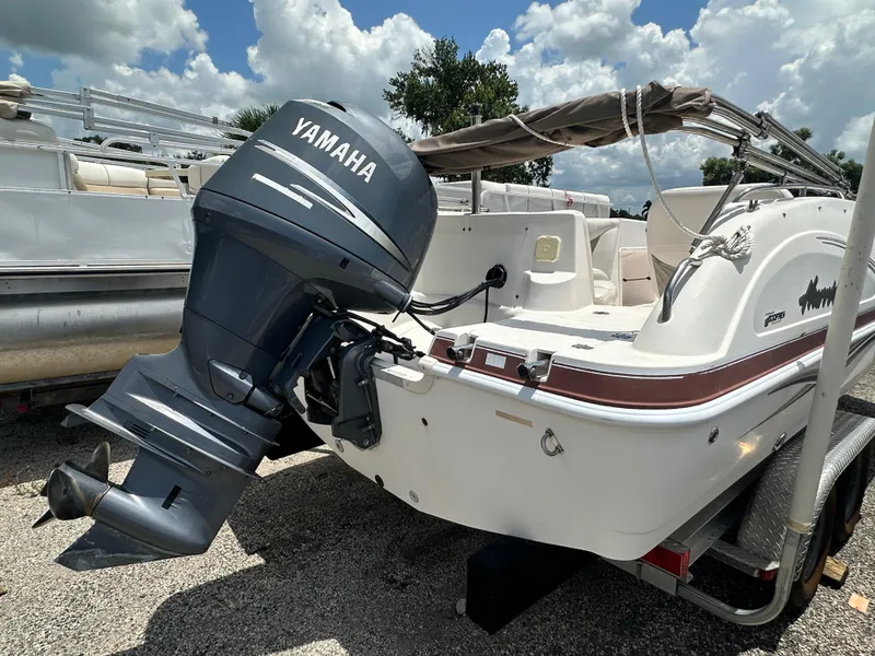 Slide: The Image of 2004 Hurricane FunDeck GS 202 OB boat with Yamaha outboard motor, parked on trailer. - 11