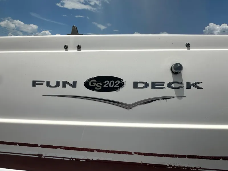 Slide: The Image of 2004 Hurricane FunDeck GS 202 OB boat logo under a blue sky. - 12