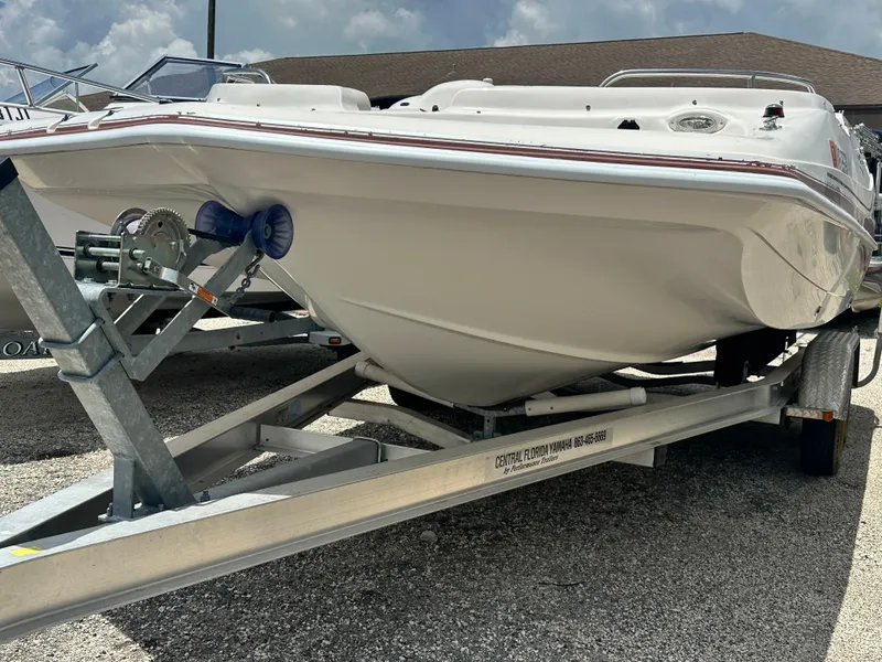 Slide: The Image of 2004 Hurricane FunDeck GS 202 OB boat on trailer, parked outdoors. - 13