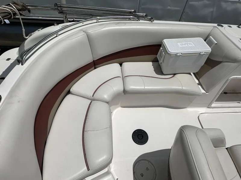 Slide: The Image of 2004 Hurricane FunDeck GS 202 OB boat interior with white seating and cooler. - 4
