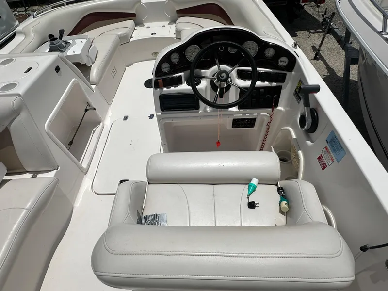 Slide: The Image of 2004 Hurricane FunDeck GS 202 OB boat interior with steering wheel and seating. - 5