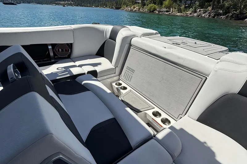 Slide: The Image of 2021 MasterCraft X24 boat interior with luxurious seating and scenic lake view. - 14