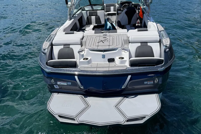 Slide: The Image of 2021 MasterCraft X24 boat with spacious seating on clear blue water. - 4