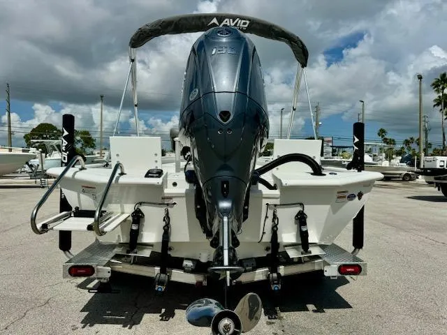 Slide: The Image of Avid 21 Mag 2025 boat with powerful outboard motor, parked on a sunny day. - 4