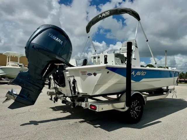Slide: The Image of Avid 21 Mag 2025 boat with Yamaha engine on trailer, parked outdoors. - 5