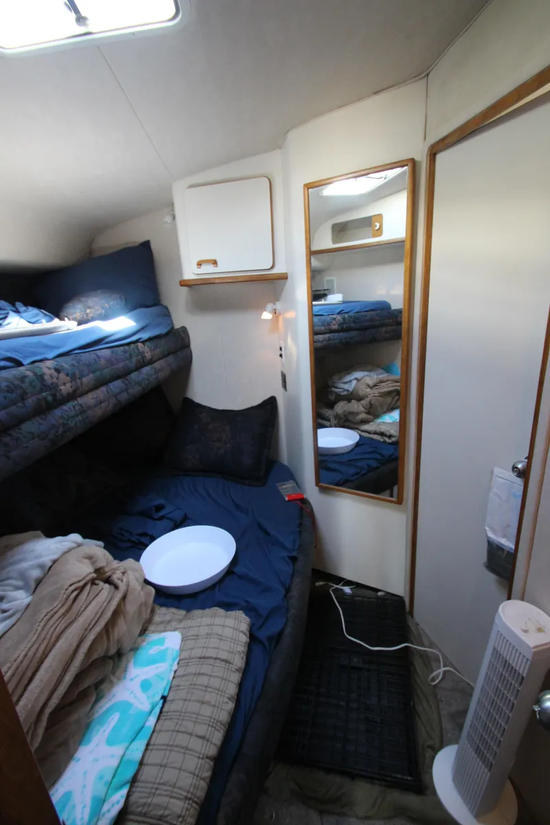 Slide: The Image of Cozy cabin interior of 1994 Sea Ray 500 Sundancer with bunk beds and mirror. - 40