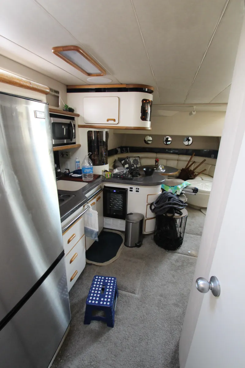 Slide: The Image of Interior of 1994 Sea Ray 500 Sundancer yacht kitchen with appliances and storage. - 46