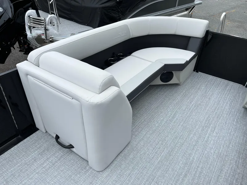 Slide: The Image of 2026 Harris Cruiser 230 boat interior with white and gray seating and carpeted floor. - 11
