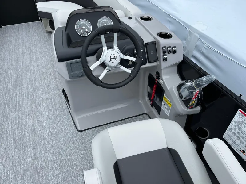 Slide: The Image of 2026 Harris Cruiser 230 boat dashboard with steering wheel and control panel. - 13