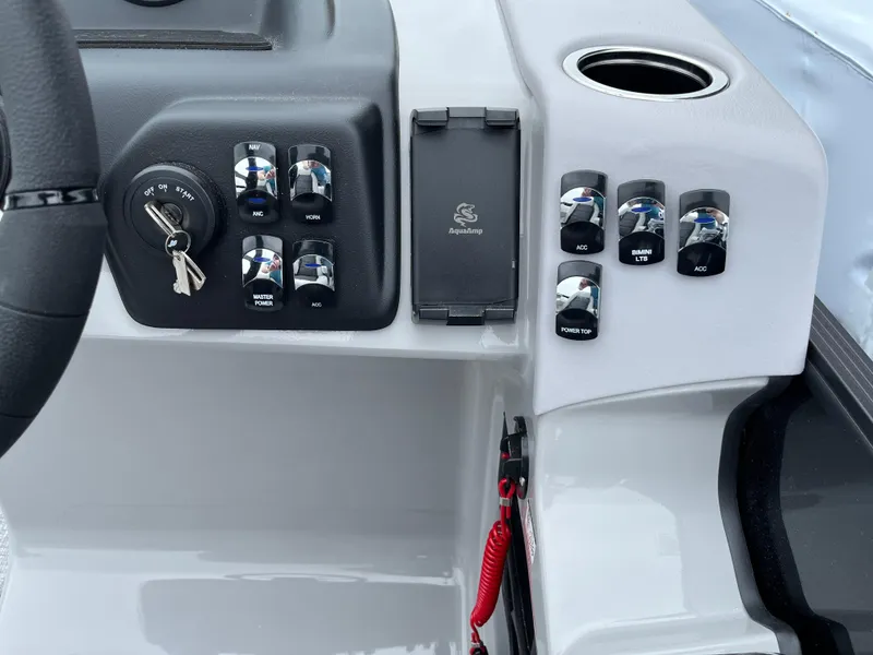 Slide: The Image of 2026 Harris Cruiser 230 dashboard with controls and ignition keys. - 14