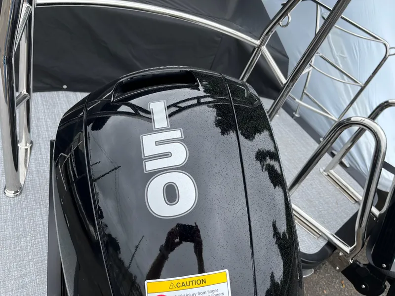 Slide: The Image of 2026 Harris Cruiser 230 boat with a 150 horsepower engine, featuring sleek design and chrome railings. - 5