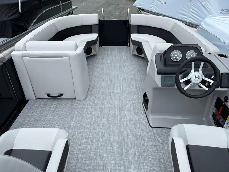 Slide: The Image of 2026 Harris Cruiser 230 interior with modern seating and steering console. - 7