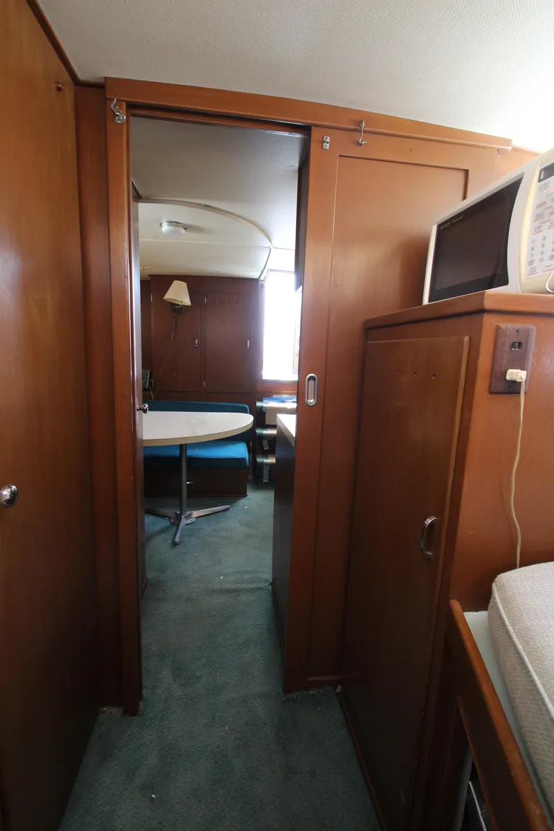 Slide: The Image of Interior of 1965 Chris-Craft Commander boat with wood paneling and dining area. - 34