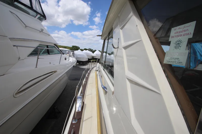 Slide: The Image of 1965 Chris-Craft Commander boat docked among other boats under a blue sky. - 8