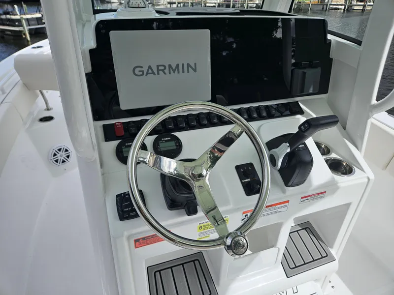 Slide: The Image of Steering console of 2025 Sea Hunt Ultra 235 SE with Garmin navigation system. - 11