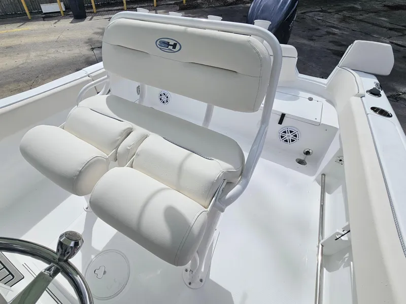 Slide: The Image of 2025 Sea Hunt Ultra 235 SE boat interior with white cushioned seating. - 13
