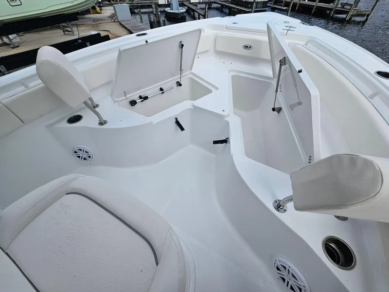 Slide: The Image of 2025 Sea Hunt Ultra 235 SE boat interior with open storage compartments. - 17